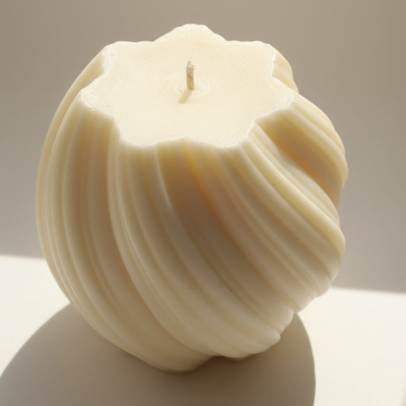 Handgemaakte crèmekleurige sojawas pillar kaars met gedraaide swirl vorm.